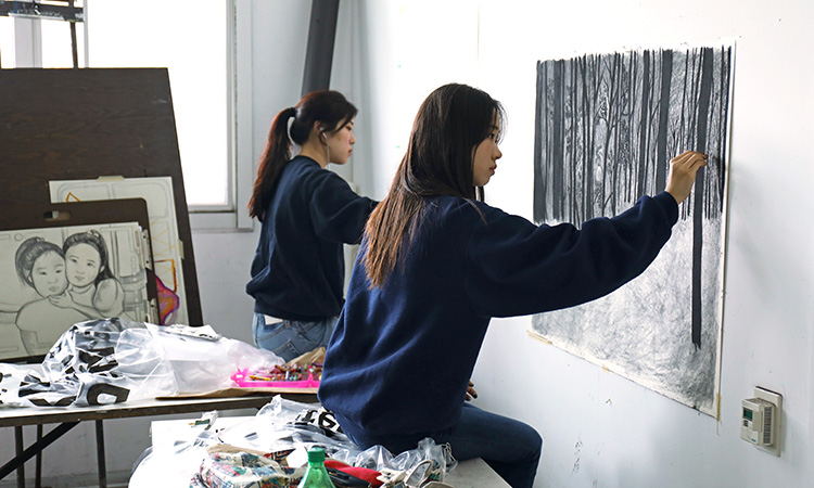 Students drawing in a classroom.