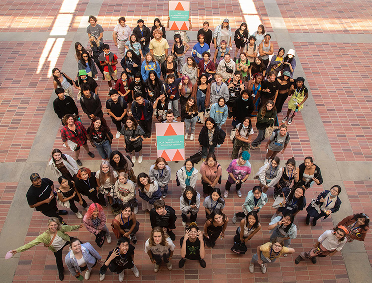 Group of students standing on a brick ground, photographed from above